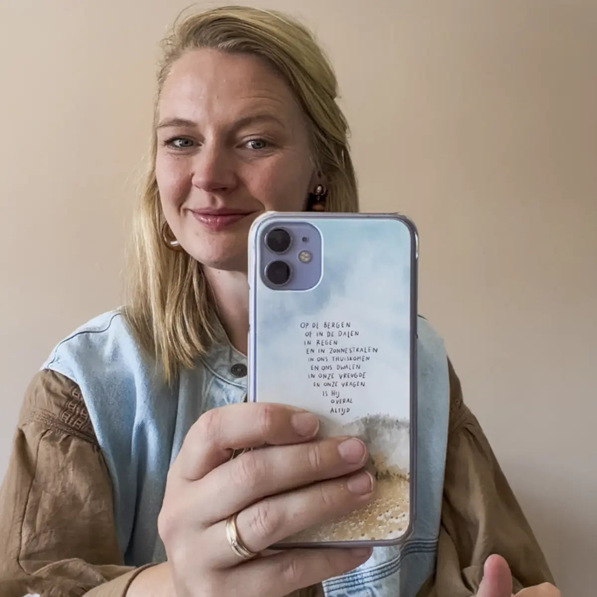 Alette Koornneef met een van haar christelijke telefoonhoesje-ontwerpen